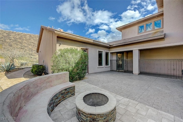 view of patio / terrace with a fire pit