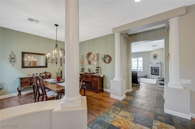 dining room featuring dark hardwood / wood-style flooring and ornate columns