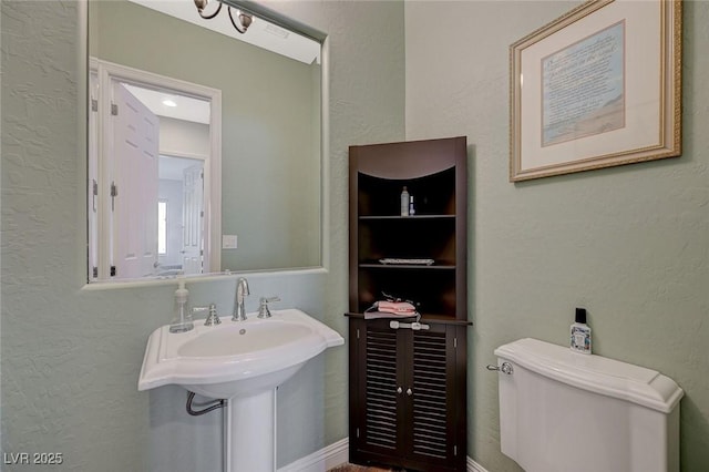 bathroom featuring sink and toilet