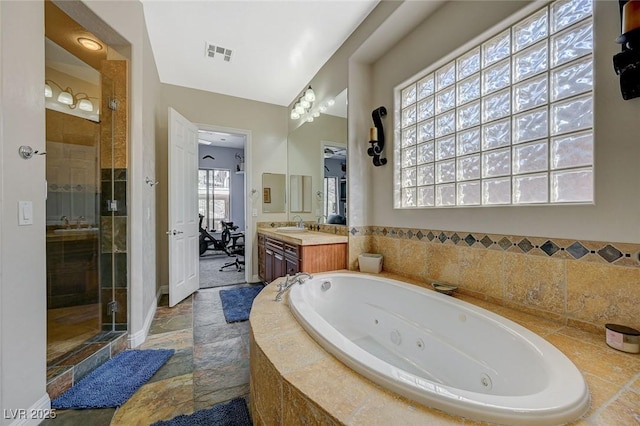 bathroom with vanity and separate shower and tub