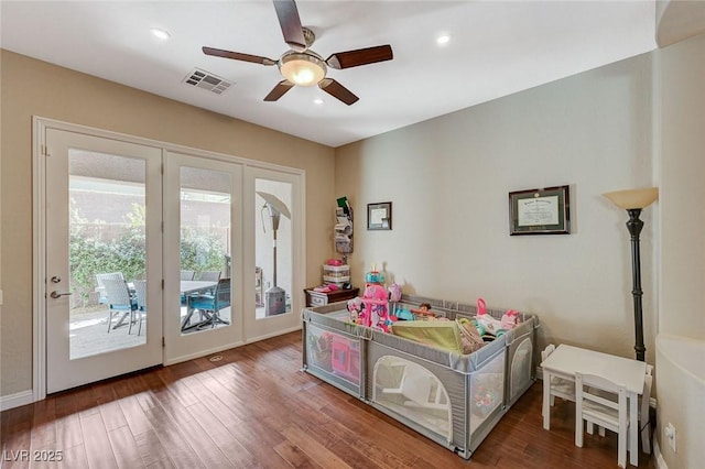 bedroom with dark wood-type flooring, access to outside, and ceiling fan