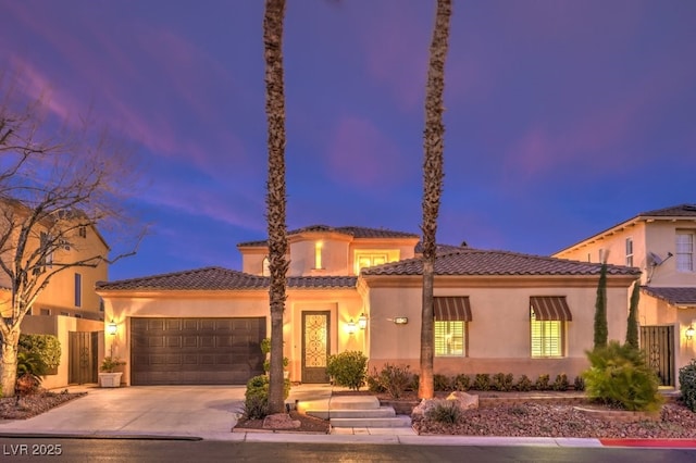 mediterranean / spanish-style house with a garage