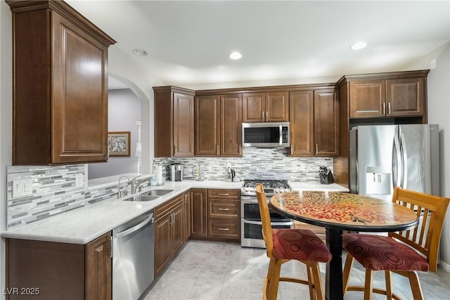 kitchen with stainless steel appliances, tasteful backsplash, and sink