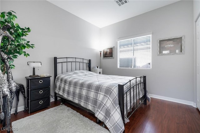 bedroom with dark hardwood / wood-style flooring