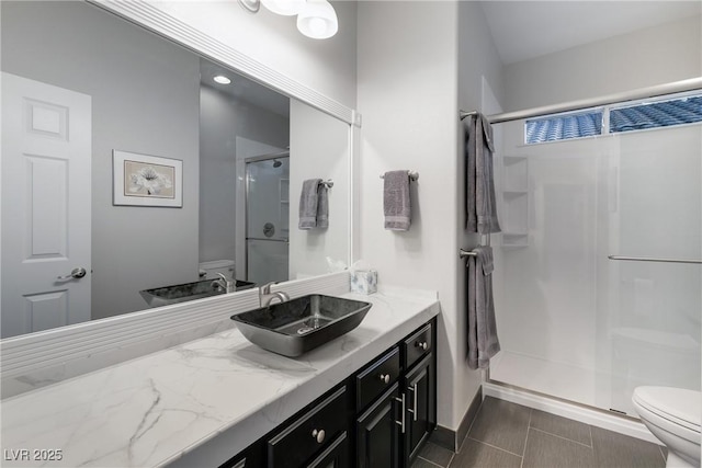 bathroom with vanity, toilet, and walk in shower