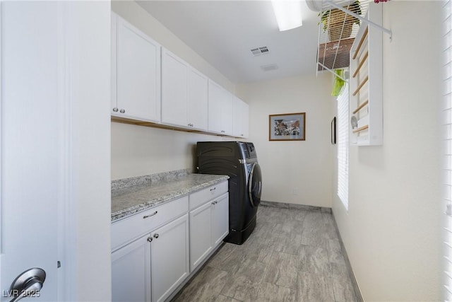 washroom featuring cabinets and washing machine and clothes dryer