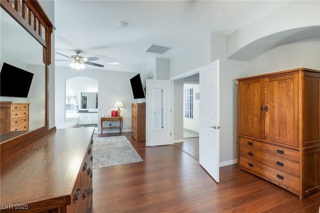 living room with ceiling fan and dark hardwood / wood-style flooring