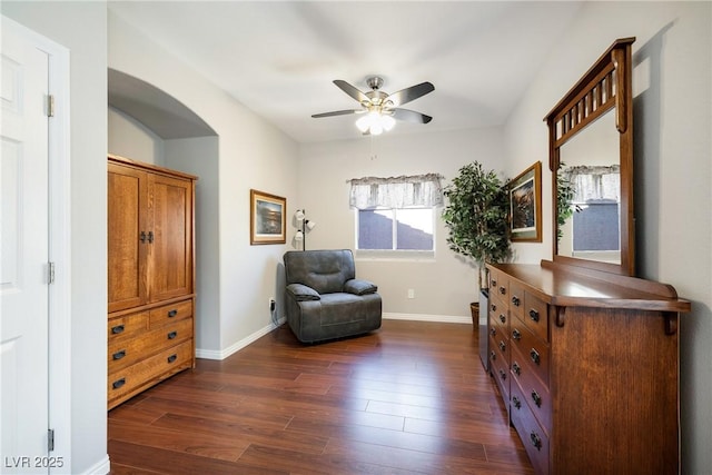 living area featuring dark hardwood / wood-style flooring and ceiling fan