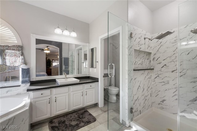 full bathroom featuring vanity, ceiling fan, plus walk in shower, and toilet