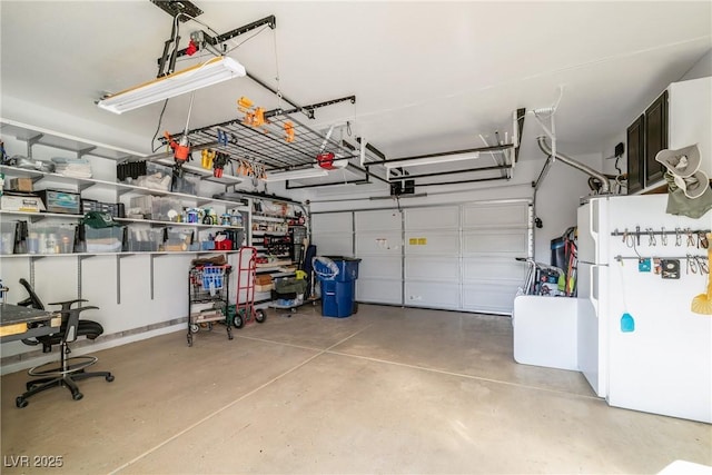 garage featuring a garage door opener and white fridge