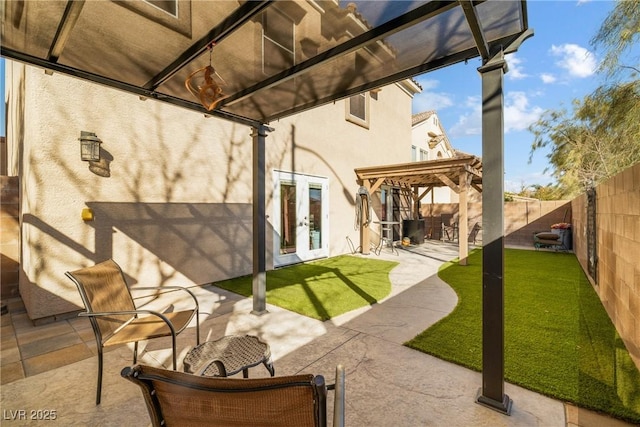 rear view of property featuring french doors, a yard, a pergola, and a patio