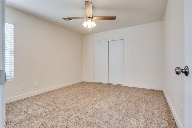 unfurnished bedroom with light carpet, ceiling fan, and a closet