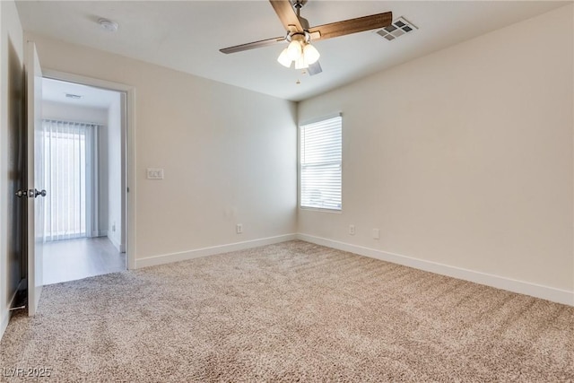 carpeted empty room featuring ceiling fan