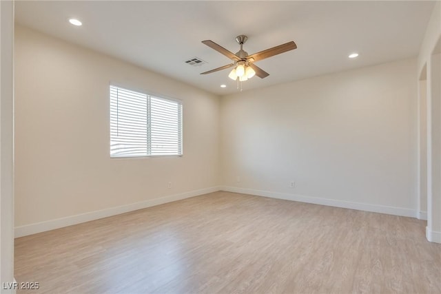 empty room with light hardwood / wood-style flooring and ceiling fan