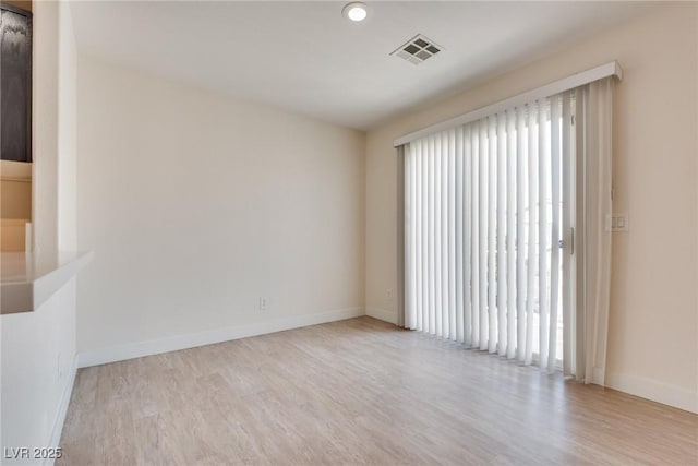 unfurnished room with light hardwood / wood-style flooring