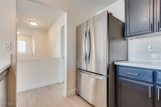 kitchen featuring appliances with stainless steel finishes and light hardwood / wood-style flooring