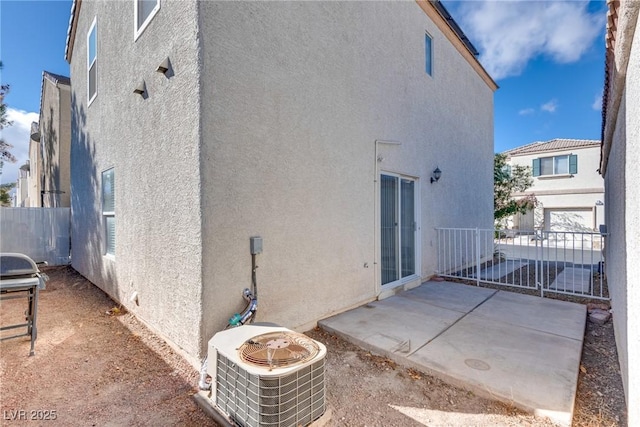 rear view of house featuring central AC and a patio area