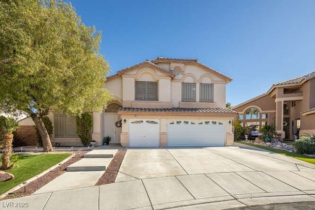 mediterranean / spanish house with a garage