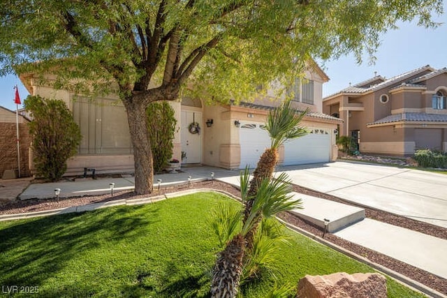 view of front of house featuring a garage and a front lawn