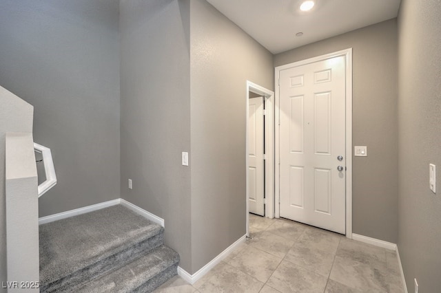 entrance foyer with light tile patterned floors and baseboards