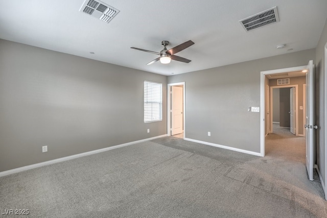 carpeted spare room with ceiling fan