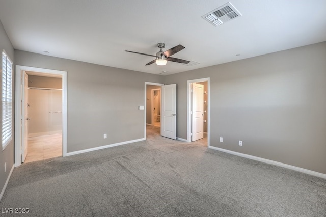 unfurnished bedroom with light carpet, ensuite bath, and ceiling fan