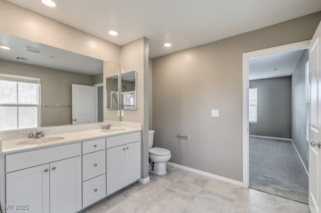 bathroom with vanity and toilet