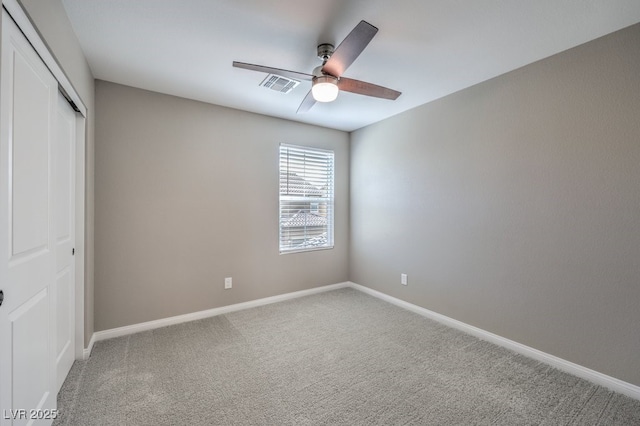 unfurnished bedroom featuring carpet floors, a closet, visible vents, ceiling fan, and baseboards