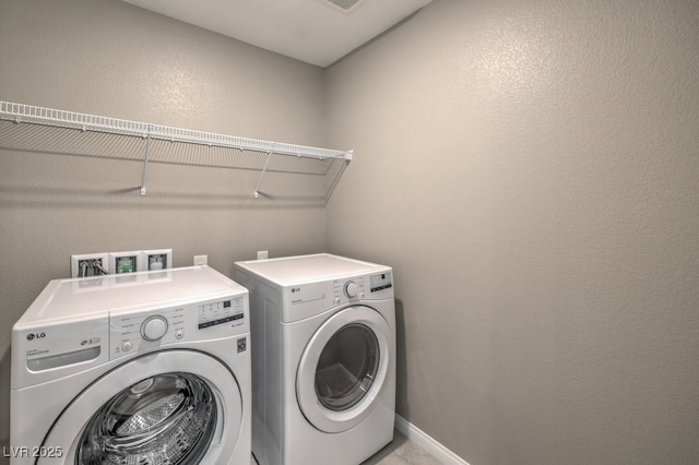 laundry room featuring washing machine and clothes dryer