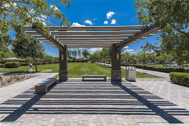 view of property's community with a lawn and a pergola