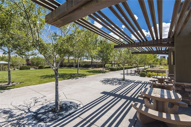 view of property's community featuring a yard, a pergola, and a patio