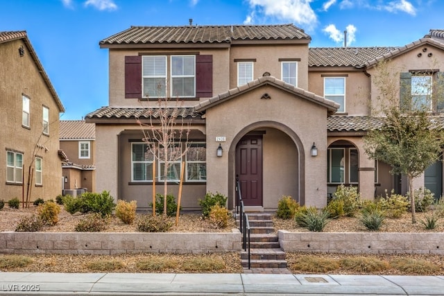 view of front of home with a tile roof and stucco siding