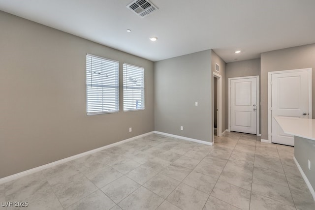 unfurnished room featuring recessed lighting, visible vents, and baseboards