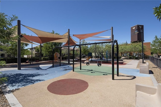 view of property's community featuring fence and playground community