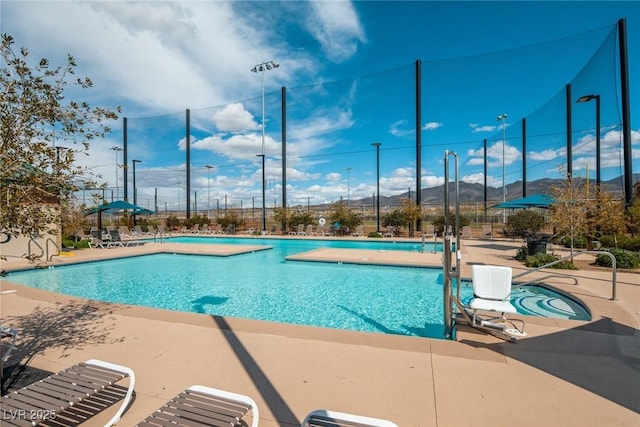 view of pool with a mountain view and a patio