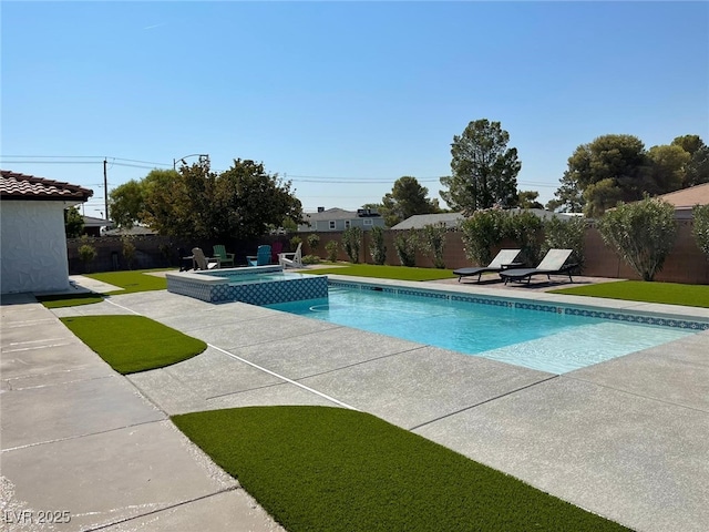 view of pool featuring an in ground hot tub, a patio, and a lawn