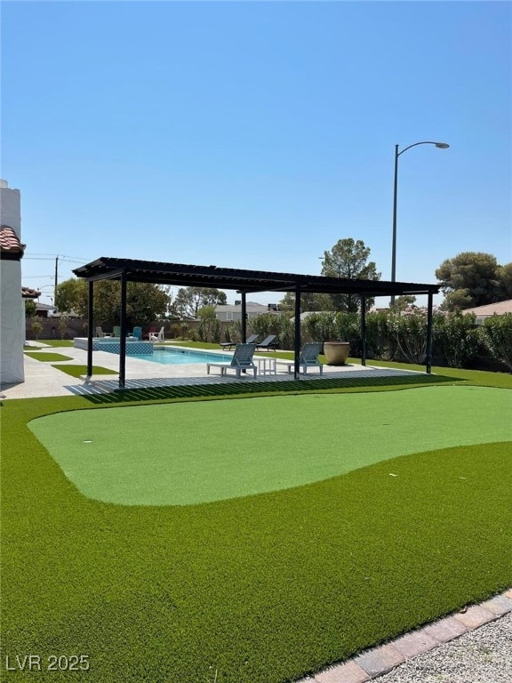 surrounding community with fence, a patio, and a swimming pool