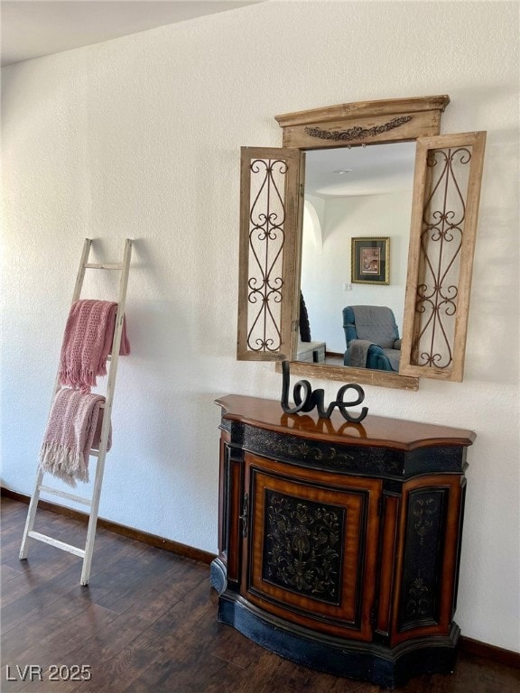 interior details featuring wood finished floors and baseboards