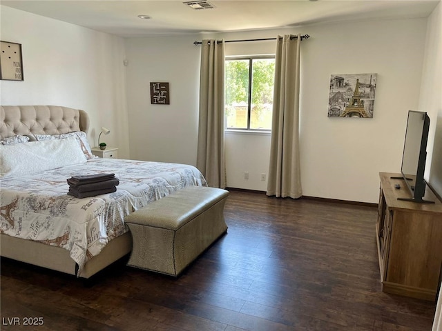 bedroom with visible vents, baseboards, and dark wood finished floors