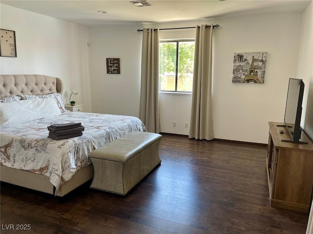 bedroom featuring visible vents, baseboards, and dark wood-type flooring