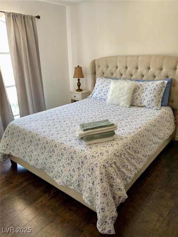 bedroom featuring dark wood-style flooring