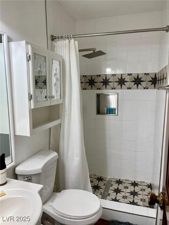 bathroom featuring a shower stall and toilet