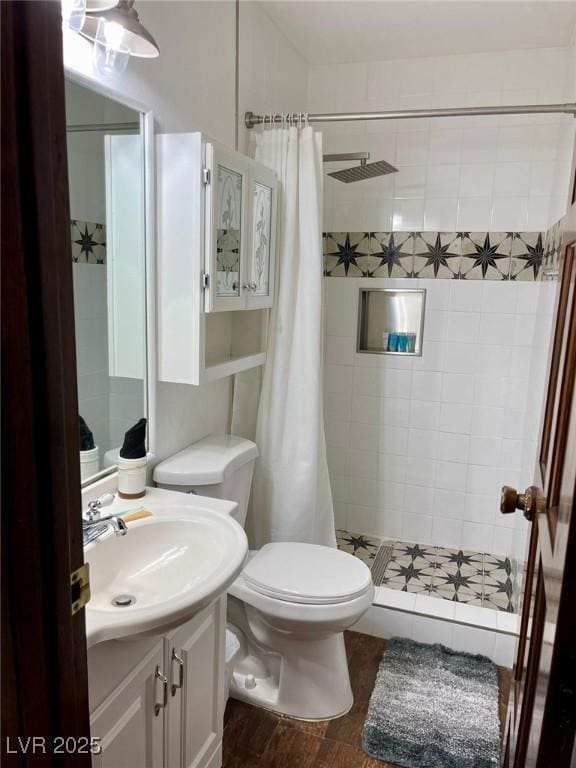 full bathroom with a shower stall, toilet, and vanity