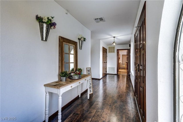 corridor with visible vents and dark wood-style flooring