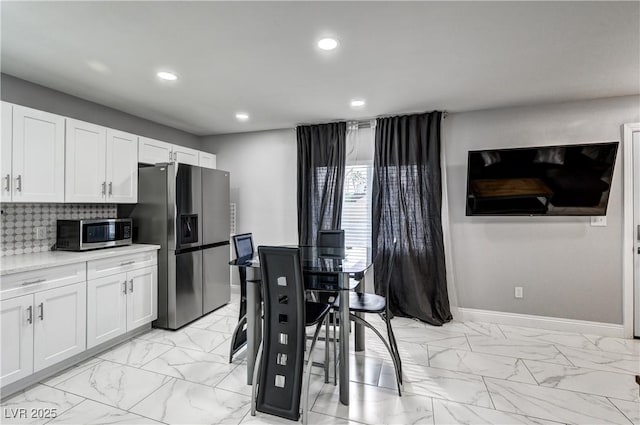 kitchen with marble finish floor, white cabinetry, light countertops, appliances with stainless steel finishes, and recessed lighting