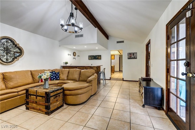 living room featuring light tile patterned flooring, visible vents, lofted ceiling with beams, and a notable chandelier
