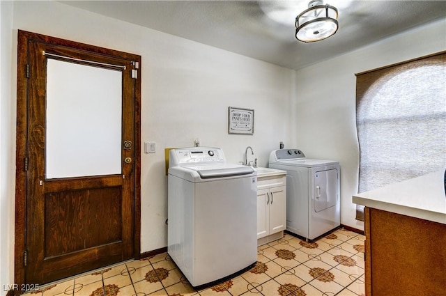 laundry room featuring a sink, baseboards, independent washer and dryer, cabinet space, and light tile patterned floors