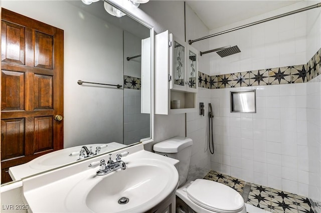 full bath featuring toilet, a sink, and tiled shower