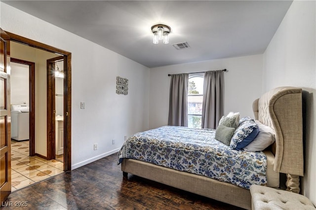bedroom with wood finished floors, visible vents, baseboards, and washer / clothes dryer
