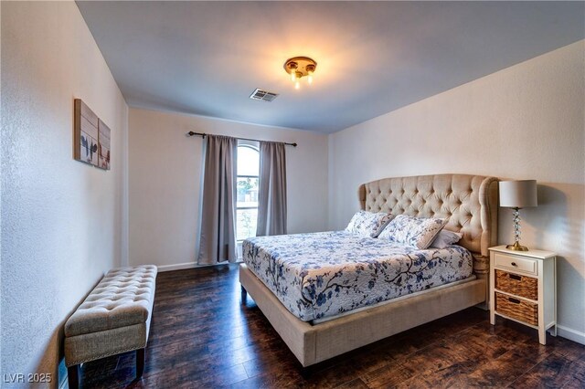 bedroom with baseboards, visible vents, and dark wood-style flooring